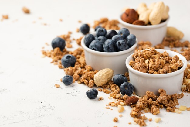 High angle of breakfast cereal with nuts and blueberries