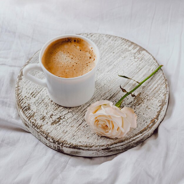 High angle of breakfast coffee with rose