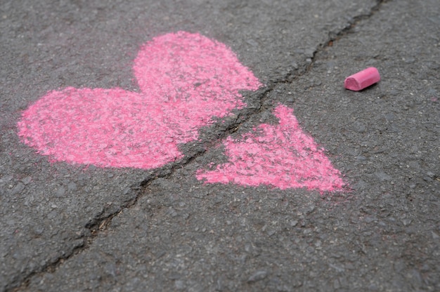 Free photo high angle of broken chalk heart on asphalt