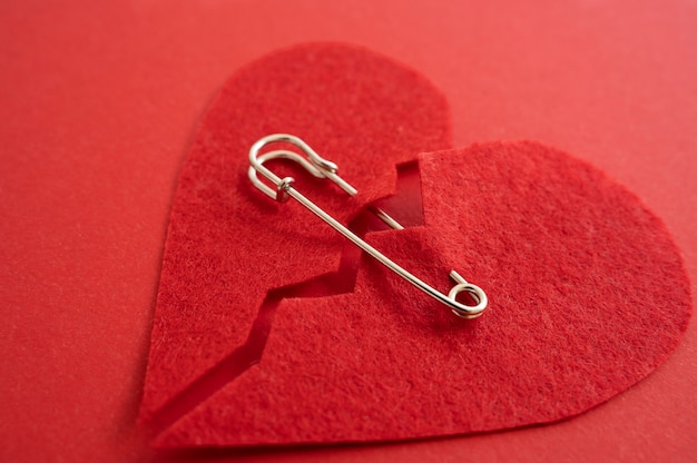 Free photo high angle of broken heart put back together with safety pin