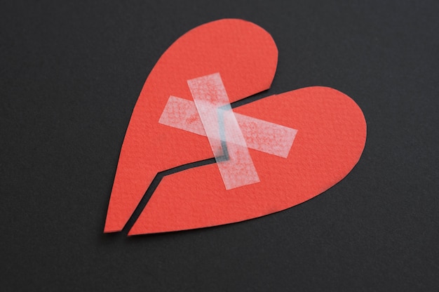 Free photo high angle of broken heart put back together with scotch tape