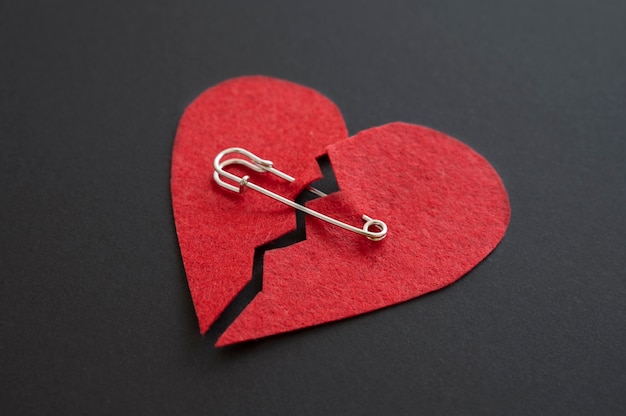 Free photo high angle of broken heart with safety pin