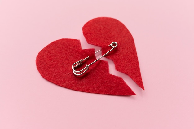 High angle of broken heart with safety pin