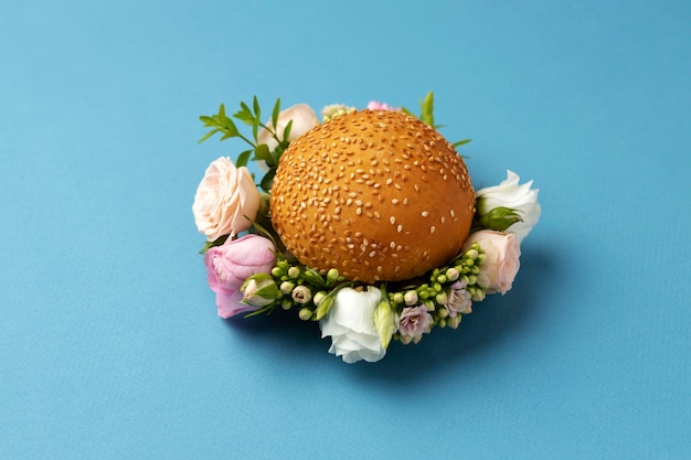 High angle burger with flowers on blue background