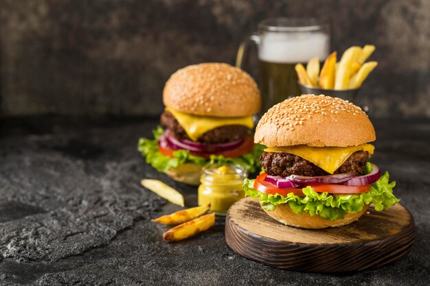 High angle burgers with fries, sauce and beer with copy-space