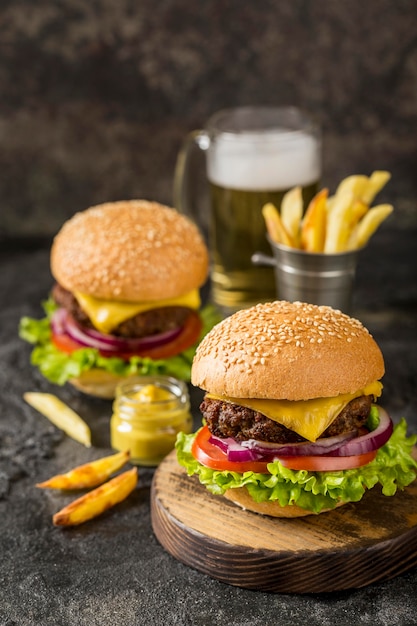 High angle burgers with fries, sauce and beer