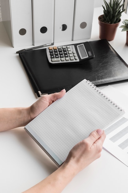 High angle business woman holding notebook