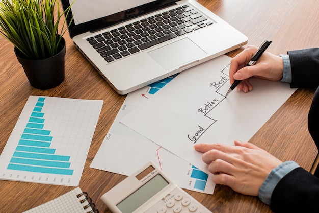 Free photo high angle of businessman with laptop at the office