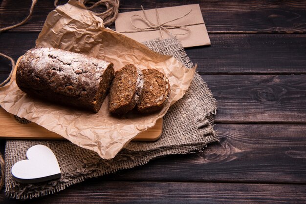 High angle of cake and slices on parchment paper