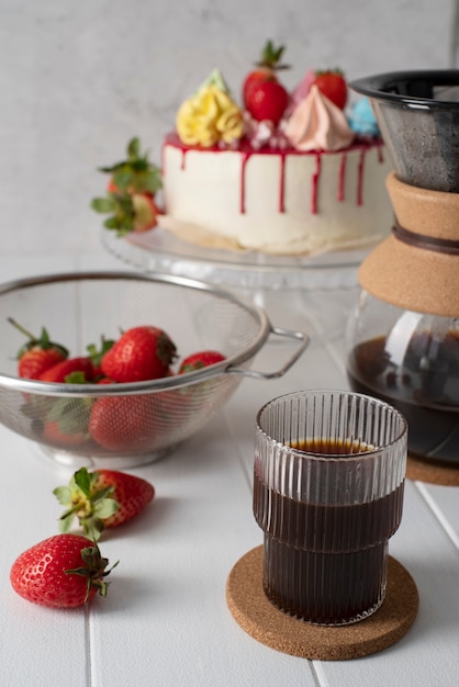 High angle cake and strawberries in bowl