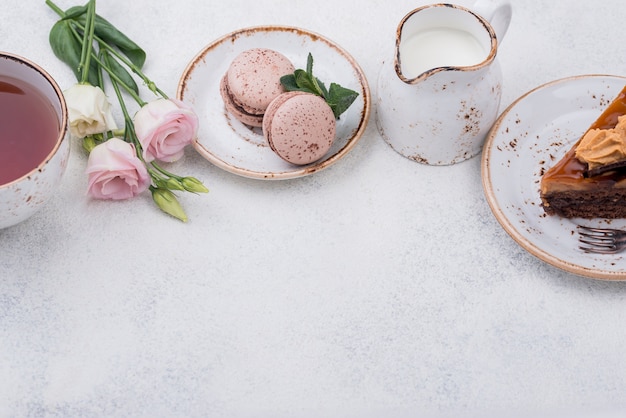 High angle of cake with macarons and tea