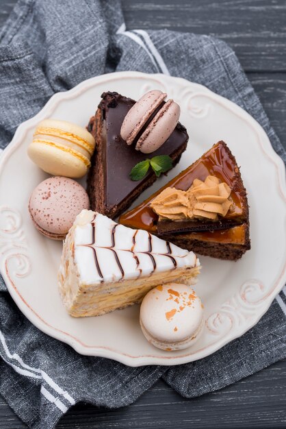 High angle of cakes on plate with macarons