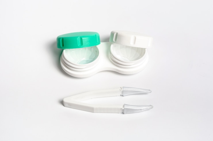 Free Photo high angle of case for contact lenses with tweezers