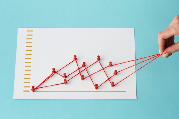 High angle of chart statistics presentation with hand