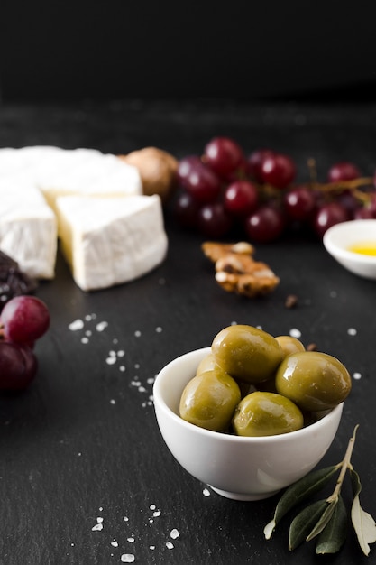 High angle cheese and olives composition on black background