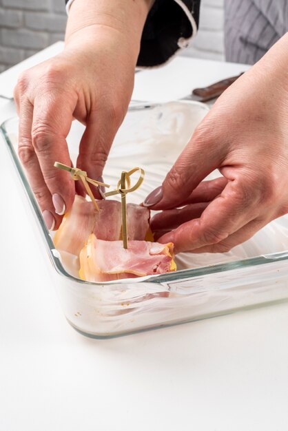 High angle of chef preparing bacon dish