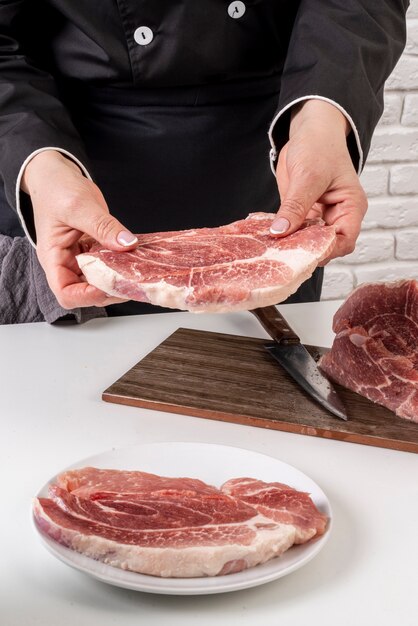 High angle of chef working with meat