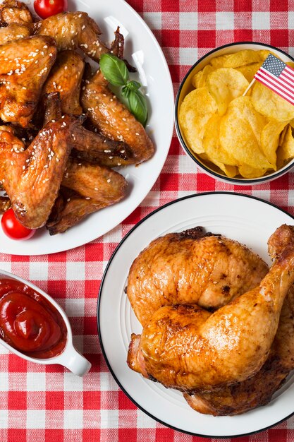 High angle chicken legs and wings with chips