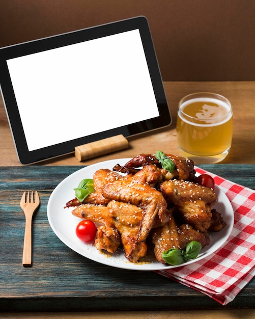 High angle chicken wings on plate with sesame seeds