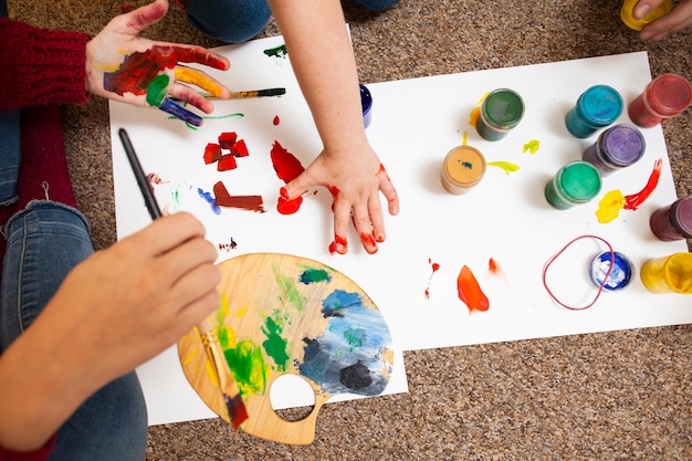 High angle of child and woman painting