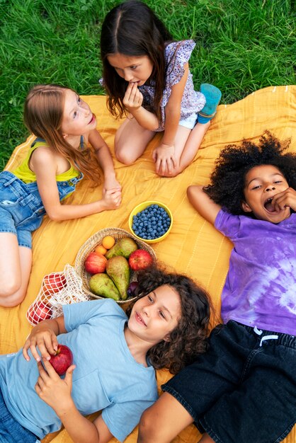 High angle children laying on cloth