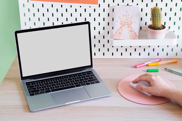 High angle of children's desk with laptop and mouse