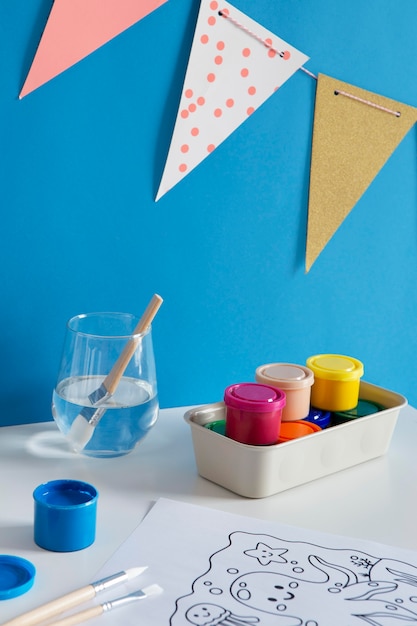 Высокий угол детского стола с краской и рисунком