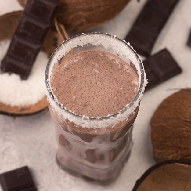 High angle of chocolate and coconut milkshake glass