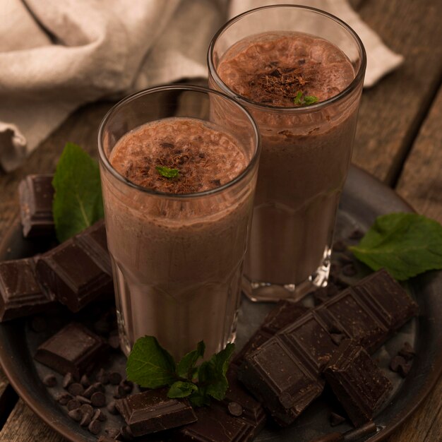 High angle of chocolate milkshake glasses on tray