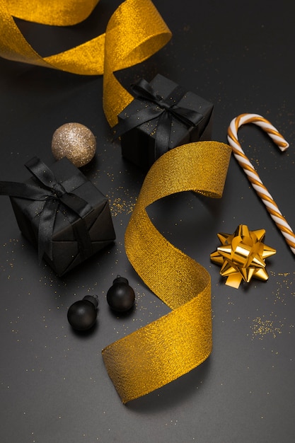 High angle of christmas ornaments with golden ribbon and presents