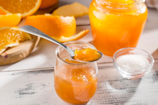 High angle of clear jar with orange jam
