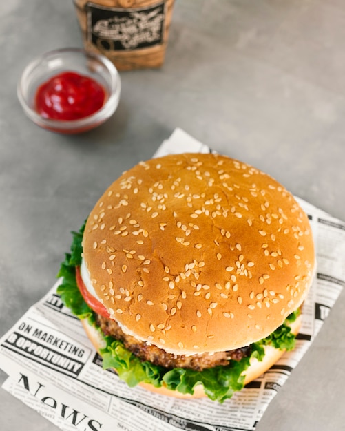 High angle close-up burger on newspaper