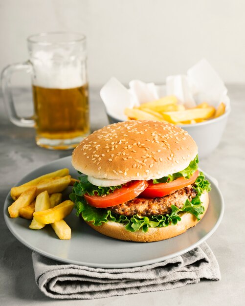 High angle close-up burger with fries on plate