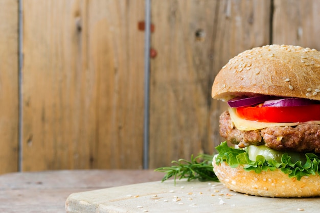 High angle close-up of burger on wooden board