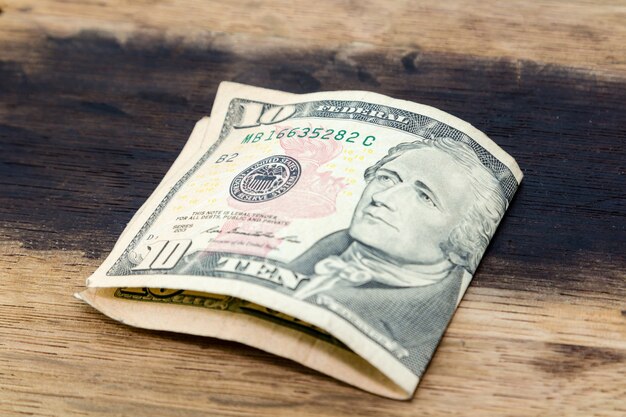 High angle closeup shot of an American dollar bill on a wooden surface