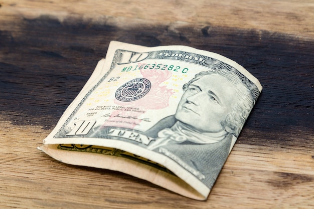 High angle closeup shot of an American dollar bill on a wooden surface