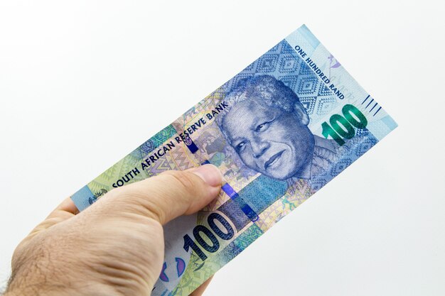 High angle closeup shot of a person holding a banknote