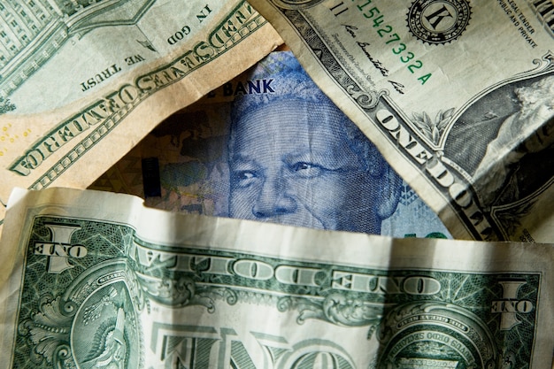 High angle closeup shot of a pile of different banknotes and cash