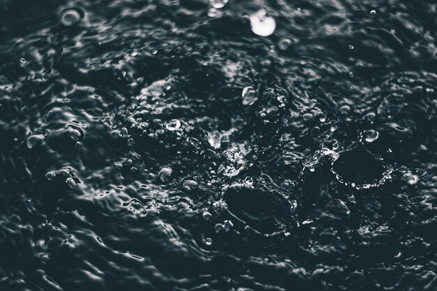 High angle closeup shot of the splashes of water on the surface of a lake