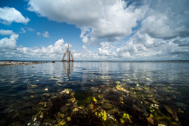 High angle closeup shot of stones on the seashore with the calm sea