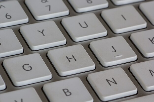 High angle closeup shot of a white keyboard