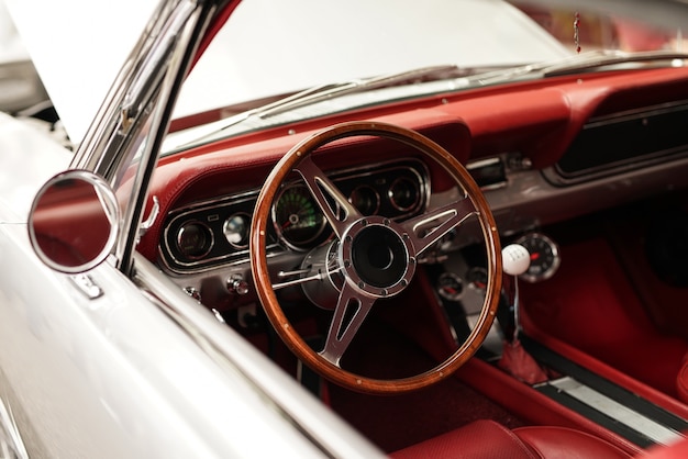 High angle closeup shot of a white retro car with a beautiful steering wheel