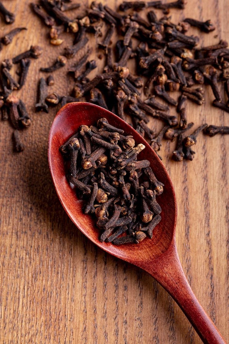 Free Photo high angle of clove in wooden spoon