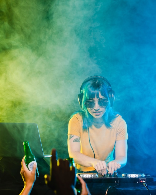 Free photo high angle clubbing time with female dj