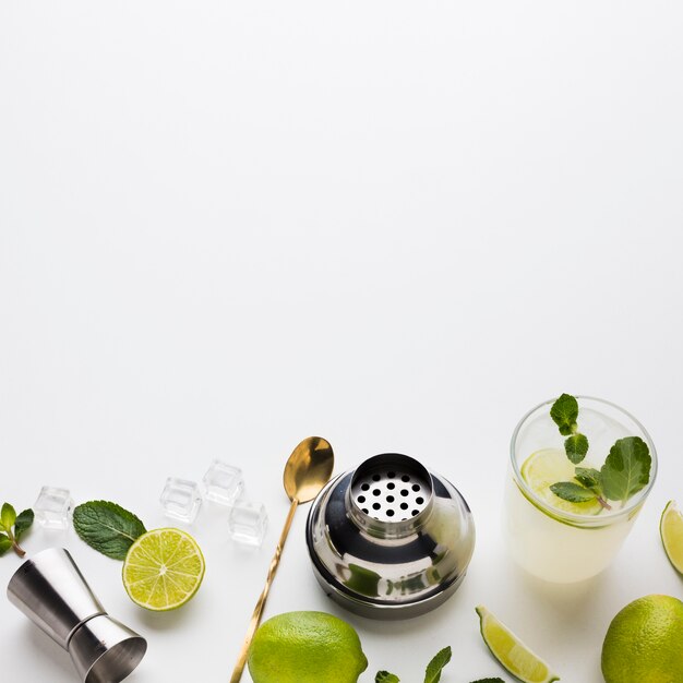 High angle of cocktail essentials with lime and mint