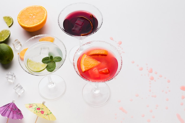 High angle of cocktail glasses with salt rim and lime