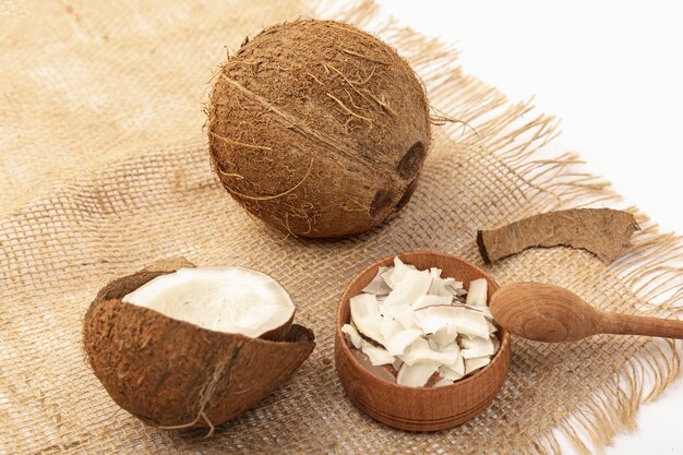 High angle of coconut on burlap with spoon