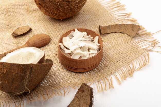 High angle of coconut with spoon and burlap