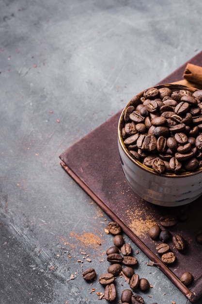 High angle coffee beans in cup on cutting board with copy-space