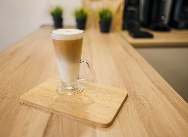 High angle of coffee beverage served on wooden plate